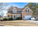Spacious two-story home with manicured lawn, featuring a two-car garage and traditional architecture at 190 Country Club Dr, Hiram, GA 30141