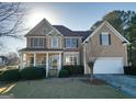 Charming two-story home with stone and tan siding, complemented by a well-maintained lawn and a two-car garage at 190 Country Club Dr, Hiram, GA 30141