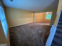 Spacious living room boasts neutral carpet, ample natural light, and staircase access to the upper level at 1472 Queenie Smith Ne Rd, Conyers, GA 30012