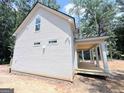 Exterior of the home featuring vinyl siding and a covered porch perfect for relaxing outdoors at 485 West Ave, Bowdon, GA 30108