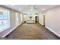 Spacious living room with hardwood floors, abundant natural light, and an open layout leading to the kitchen at 485 West Ave, Bowdon, GA 30108