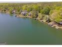 Stunning aerial view of lakefront homes surrounded by lush greenery at 1252 Heritage Dr, Villa Rica, GA 30180
