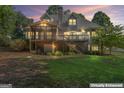 Expansive backyard view with a screened porch, deck, and lush greenery at 914 Champions Way, Mcdonough, GA 30252