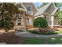 Close up of the home's entryway featuring stone facade and a well-manicured lawn at 914 Champions Way, Mcdonough, GA 30252
