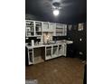 Unique kitchen featuring contrasting black walls and white cabinets, providing a modern and eye-catching design at 4619 S Seminole Dr, Douglasville, GA 30135
