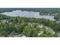 Stunning aerial view showcases lakeside homes surrounded by lush greenery and mature trees at 107 Edgewater Way, Peachtree City, GA 30269
