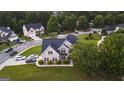 Aerial view of neighborhood with brick home featuring a manicured lawn, lush landscaping at 184 Fashion Xing, Mcdonough, GA 30252