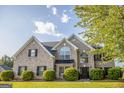 Charming brick home featuring a manicured lawn, lush landscaping, and a classic architectural design at 184 Fashion Xing, Mcdonough, GA 30252