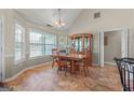 Dining room features large windows, a classic wood table with chairs, and a beautiful china cabinet at 603 Rossie Court, Mcdonough, GA 30252