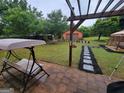 The backyard boasts a large, fenced yard with seating, perfect for outdoor relaxation at 45 Oak Wood Lane, Covington, GA 30016