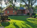 Single-Gathering home with a well-manicured lawn and established landscaping, creating a welcoming exterior at 45 Oak Wood Lane, Covington, GA 30016