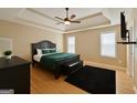A spacious main bedroom showcases a tray ceiling, fan, and ample natural light at 45 Oak Wood Lane, Covington, GA 30016