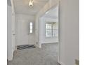 Bright foyer with fresh paint, a large window, and modern gray carpet throughout at 100 Walnut Ct, Stockbridge, GA 30281