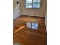 Bedroom featuring gleaming hardwood floors and a sun-filled window at 3211 Rockview Dr, Lithonia, GA 30038