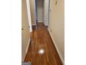 Hallway boasts gleaming hardwood floors and neutral-toned walls at 3211 Rockview Dr, Lithonia, GA 30038