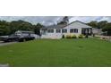 Spacious single-story home with a lush front lawn and driveway, perfect for Gathering living at 1 Hemlock, Porterdale, GA 30014