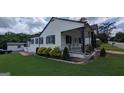Charming single-story home with a large front yard, covered porch, and well-maintained landscaping at 1 Hemlock, Porterdale, GA 30014