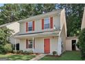 Charming two-story home with red shutters and front door, set in a lush, green environment at 162 Watercress Ct, Stockbridge, GA 30281