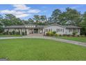 Charming single-story home with well-manicured lawn, stone walkway, and inviting front entrance at 396 Ebenezer Rd, Fayetteville, GA 30215