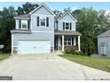 Inviting two-story home with a two-car garage and driveway, set against a backdrop of lush greenery at 248 Webster Lake Dr, Temple, GA 30179