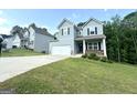 Well-maintained two-story home featuring a two-car garage and a sloping front yard with lush green grass at 248 Webster Lake Dr, Temple, GA 30179