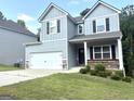 Traditional two-story home featuring a two-car garage and meticulously maintained landscaping, enhancing its curb appeal at 248 Webster Lake Dr, Temple, GA 30179
