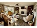 Cozy living room showcasing a brick fireplace, wood floors, and bright natural light at 4790 Hwy 101 N, Rockmart, GA 30153