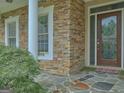 Close up of front entrance displaying stone work and patterned tile at 834 Chalet Hills, Mcdonough, GA 30253