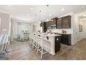 Modern kitchen with island seating, stainless steel appliances, and ample cabinet space at 10422 Trellis Lane (Lot 38), Hampton, GA 30228