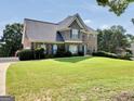 Beautiful two-story home boasting a spacious green lawn and classic design elements at 106 Big Cotton Trl, Mcdonough, GA 30252