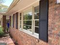 Brick facade with large windows, black shutters and manicured landscaping at 3746 Gladney Dr, Atlanta, GA 30341