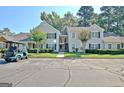 Apartment complex with nice lawns, mature trees, and condo entrances in the front at 504 Ridgelake Dr, Peachtree City, GA 30269