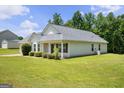Well-maintained home with a lush lawn, showcasing its side view and inviting landscape at 120 Bramble Bush Trl, Covington, GA 30014