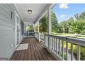 Inviting covered front porch featuring a swing and classic wood railing at 1120 Rawlings Dr, Rutledge, GA 30663