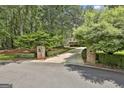 Long, winding driveway leading to the home, flanked by manicured landscaping and mature trees at 140 Silvermere, Fayetteville, GA 30215