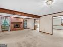 Open living room featuring a brick fireplace and large windows with plenty of natural light at 25 Ridgeview Dr, Jonesboro, GA 30236