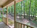 Inviting covered porch showcasing peaceful views of a verdant, tree-filled backyard at 25 Ridgeview Dr, Jonesboro, GA 30236