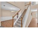 Welcoming two-story foyer featuring hardwood floors and an elegant staircase at 362 Interlake Pass, Mcdonough, GA 30252