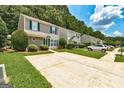 Two-story home with a concrete driveway, healthy lawn, and green shutters on the windows at 134 Watercress Ct, Stockbridge, GA 30281