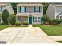 Inviting two-story home with green shutters, a tidy lawn, and a concrete driveway leading to the entrance at 134 Watercress Ct, Stockbridge, GA 30281
