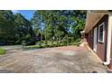 Brick home featuring mature trees and a well-manicured front yard at 1527 Patricia Dr, Morrow, GA 30260
