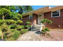 Charming brick home featuring a front entrance with decorative landscaping at 1527 Patricia Dr, Morrow, GA 30260