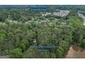 Expansive aerial view of the property, showcasing its wooded acreage and location near downtown Covington at 6111 Old Monticello Se St, Covington, GA 30014