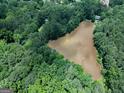Scenic aerial shot of a pond, revealing the tranquil natural beauty of the land at 6111 Old Monticello Se St, Covington, GA 30014