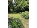 Lush backyard with mature trees and blooming hydrangea, perfect for relaxation at 1597 Joseph E Boone Nw Blvd, Atlanta, GA 30314