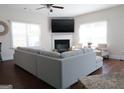 The living room offers a cozy fireplace, large windows, and comfortable seating, perfect for relaxation and entertaining guests at 11096 Cornerstone Way, Hampton, GA 30228