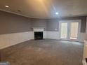 Spacious living room with neutral carpet, fireplace and white wainscoting at 2052 Charter Ln, Lithonia, GA 30058