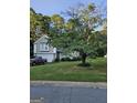 Landscaped front yard with mature tree and view of the house at 620 Ashton Ln, Lawrenceville, GA 30044