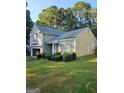 A charming home shows off its manicured lawn and tidy shrubbery at 620 Ashton Ln, Lawrenceville, GA 30044