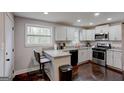 Modern kitchen with stainless steel appliances, granite countertops, and a convenient breakfast bar at 130 Mount Zion Sw Rd, Atlanta, GA 30354